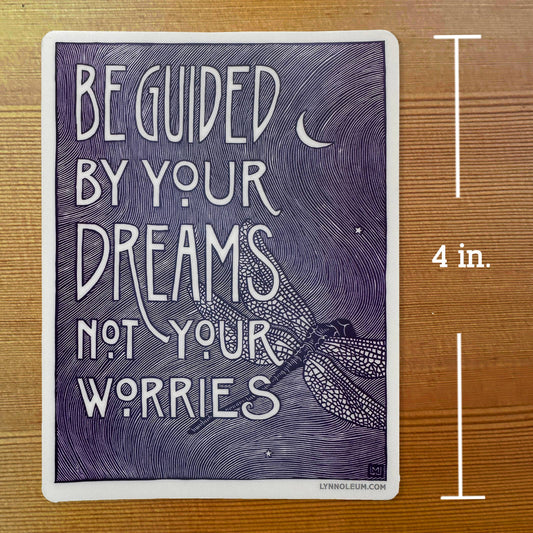 Purple quote sticker with white border: 'Be guided by your dreams, not your worries' moon