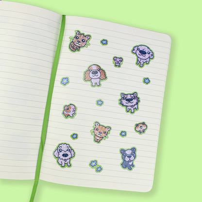 Animal stickers placed on a lined notebook page with blue flower accents