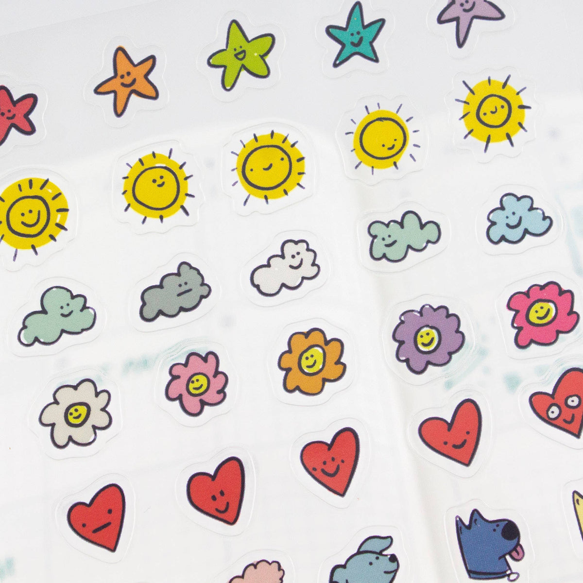 Sheet of clear planner stickers with sun, cloud, star, flower, and heart icons