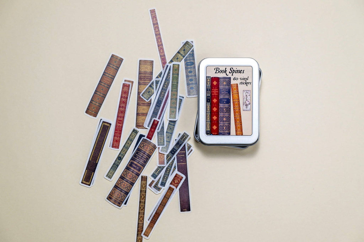 Book spine sticker tin box with colorful strip stickers scattered around