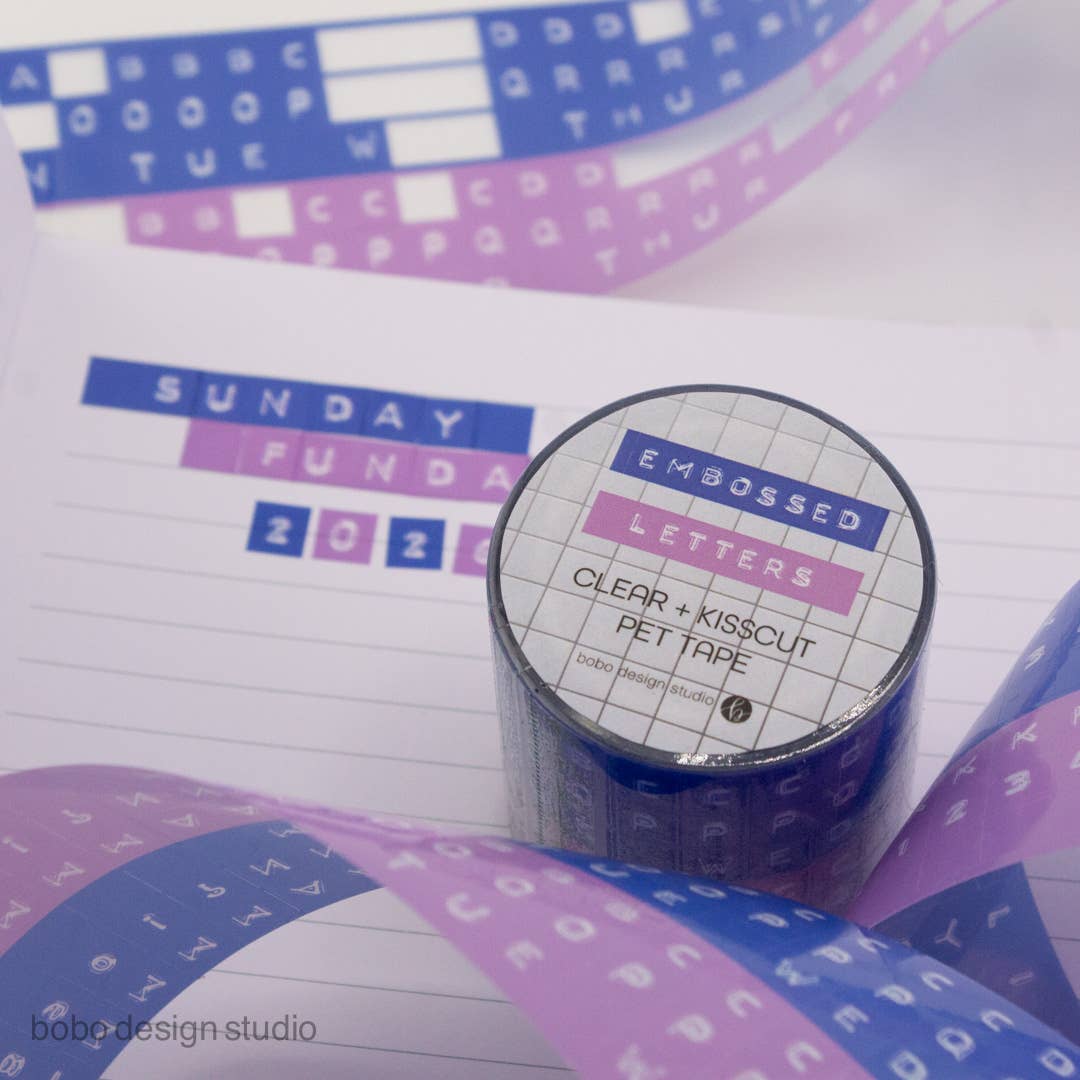 Embossed letters kiss-cut PET tape roll, clear backing with blue and lavender letter set
