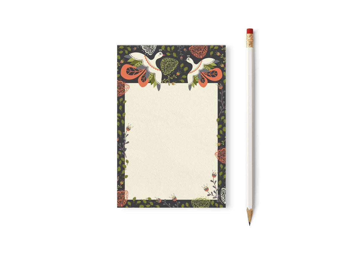 Floral notepad with two bird illustrations and a patterned border, shown beside a pencil
