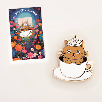 Cat latte enamel pin beside floral gift card showing cat in latte cup