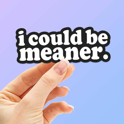 Funny quote sticker reading "i could be meaner." held in a hand