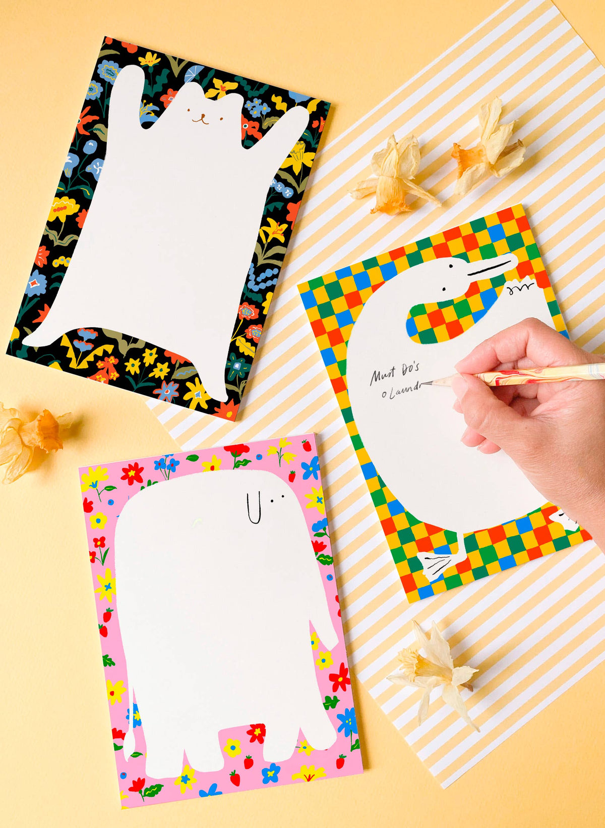 Bear-shaped floral notepad with a blank writing area, shown beside other illustrated notepads.
