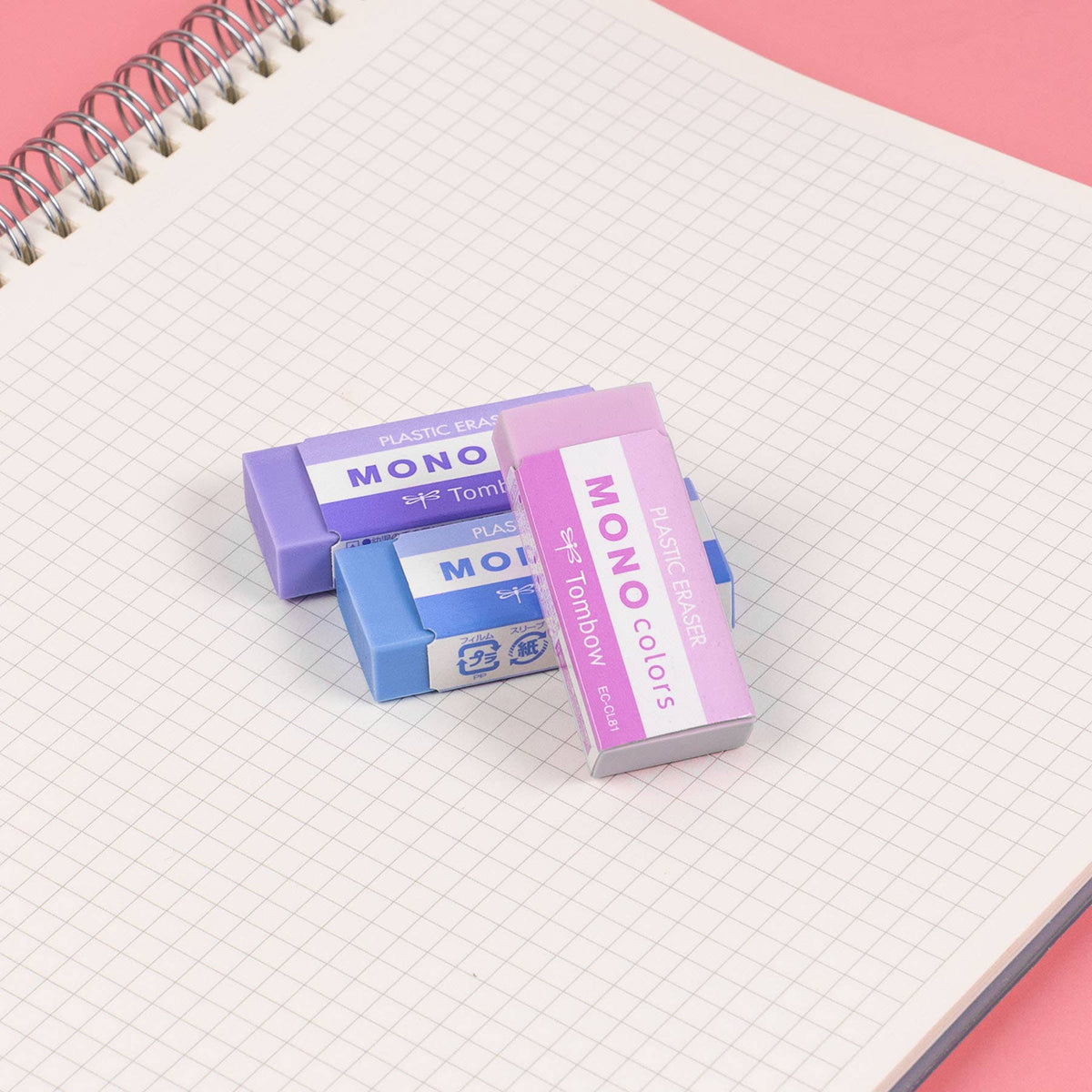 Three MONO Colors erasers in purple, blue, and pink wrappers