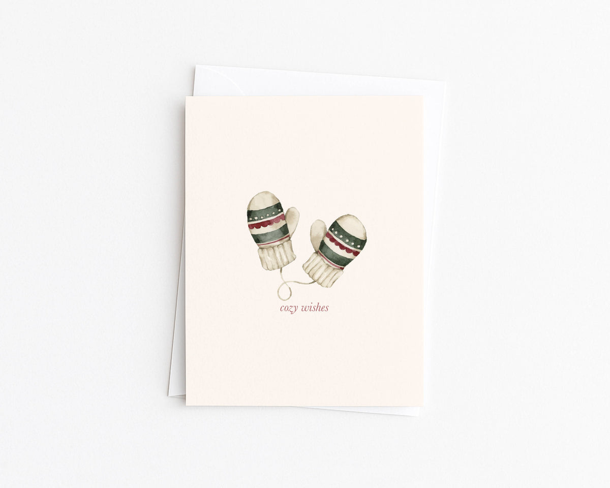 Christmas card with watercolor winter mittens illustration and “cozy wishes” text