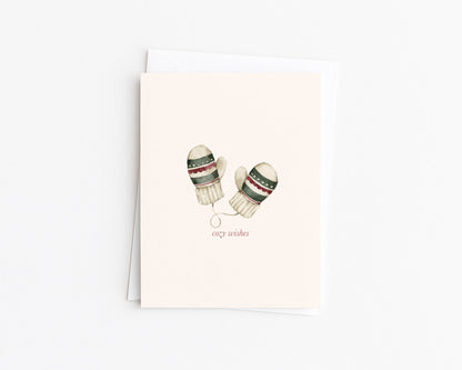 Christmas card with watercolor winter mittens illustration and “cozy wishes” text