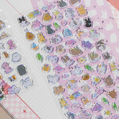 Close-up of pink-themed holographic cat stickers with ears, hearts, and small accessories.