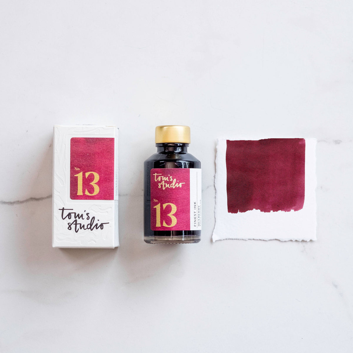 Fountain pen ink bottle and maroon mulberry ink swatch