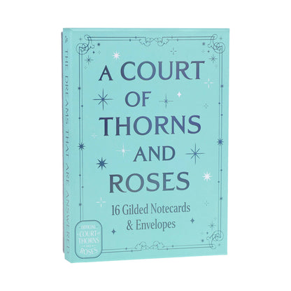 Teal gilded notecard box with gold 'A COURT OF THORNS AND ROSES' title and star details