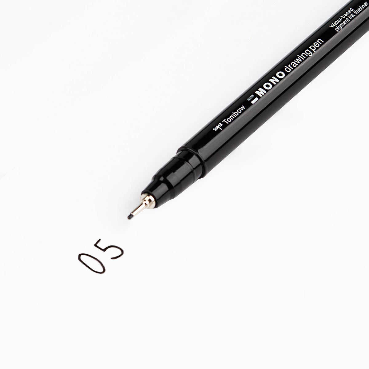 Black MONO drawing pen with fine metal tip and clip, single pen close-up
