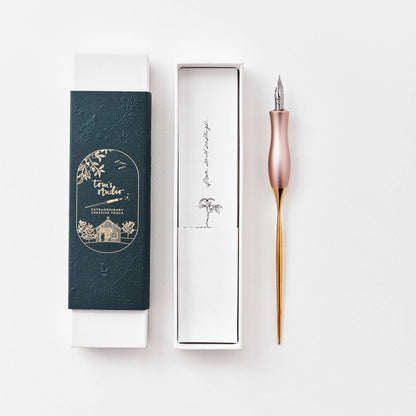 Pink calligraphy pen with oblique nib and gold accents, shown with gift box and case