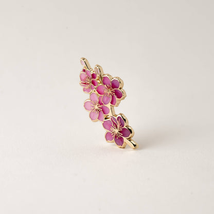 Pink cherry blossom enamel pin with gold-tone accents, side view