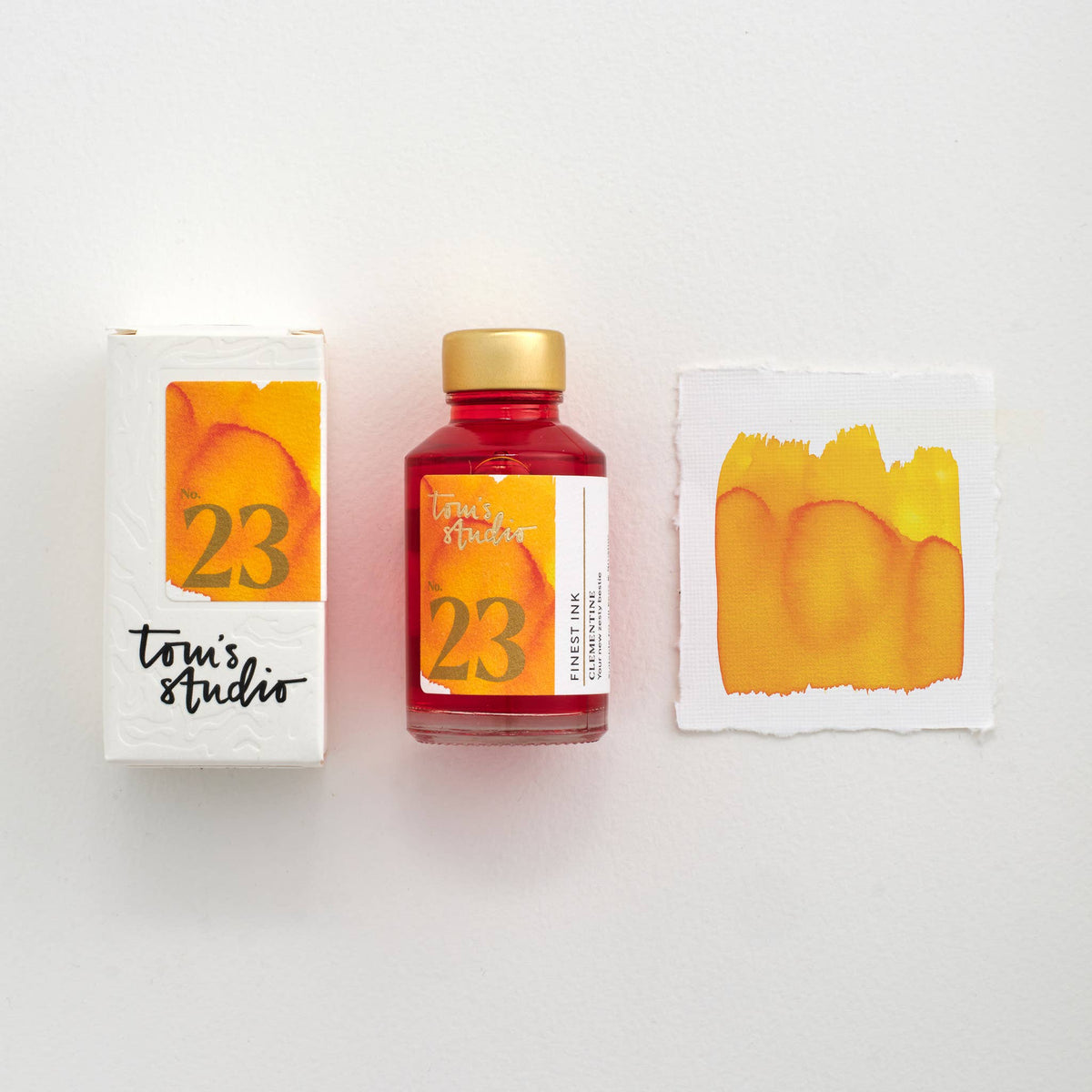 Fountain pen ink bottle with orange 23 label and ink swatch cards