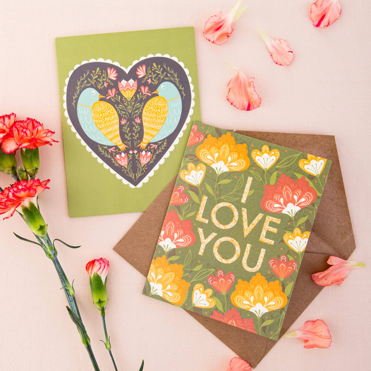 Romantic greeting card with two birds in a heart beside a floral “Love You” card