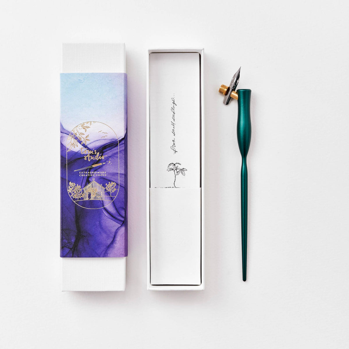 Teal-green flourish calligraphy pen with angled nib and gold accent ring
