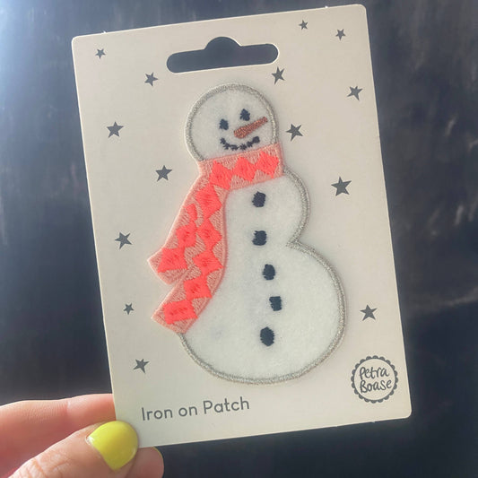 Close-up snowman iron-on embroidered felt patch with orange scarf and three-button body
