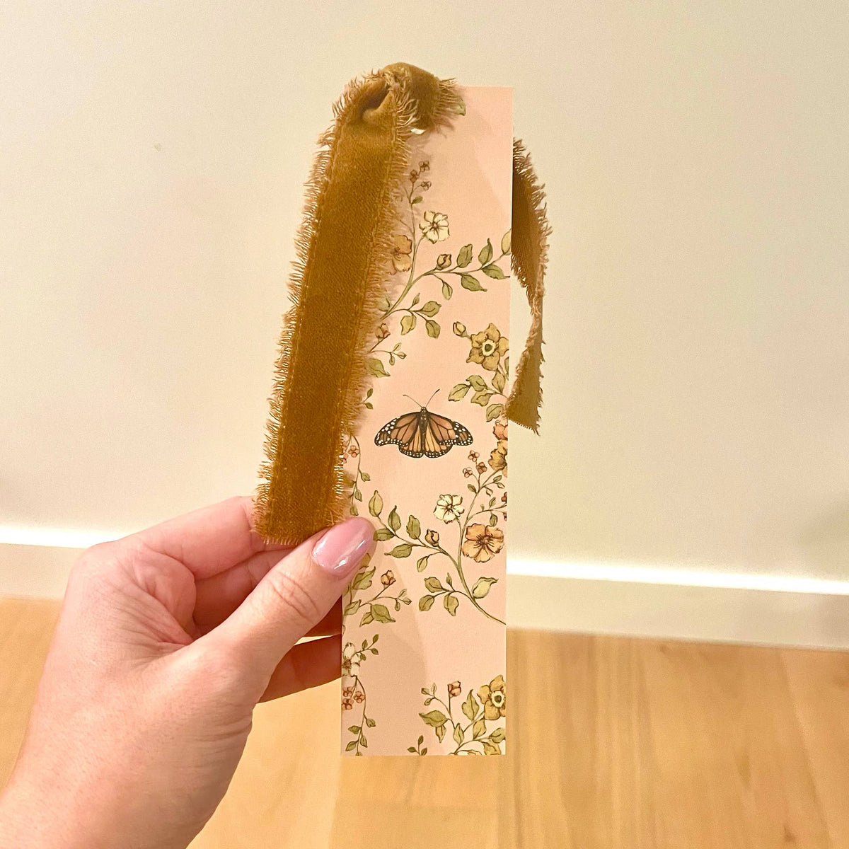 Double-sided bookmark with floral butterfly print and fuzzy velvet ribbon tie