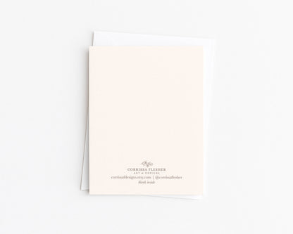 Greeting card back with small printed details and brand/contact text at bottom