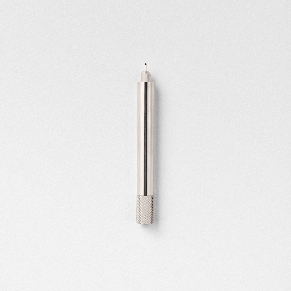 Stainless steel fountain pen with textured grip section and pointed tip