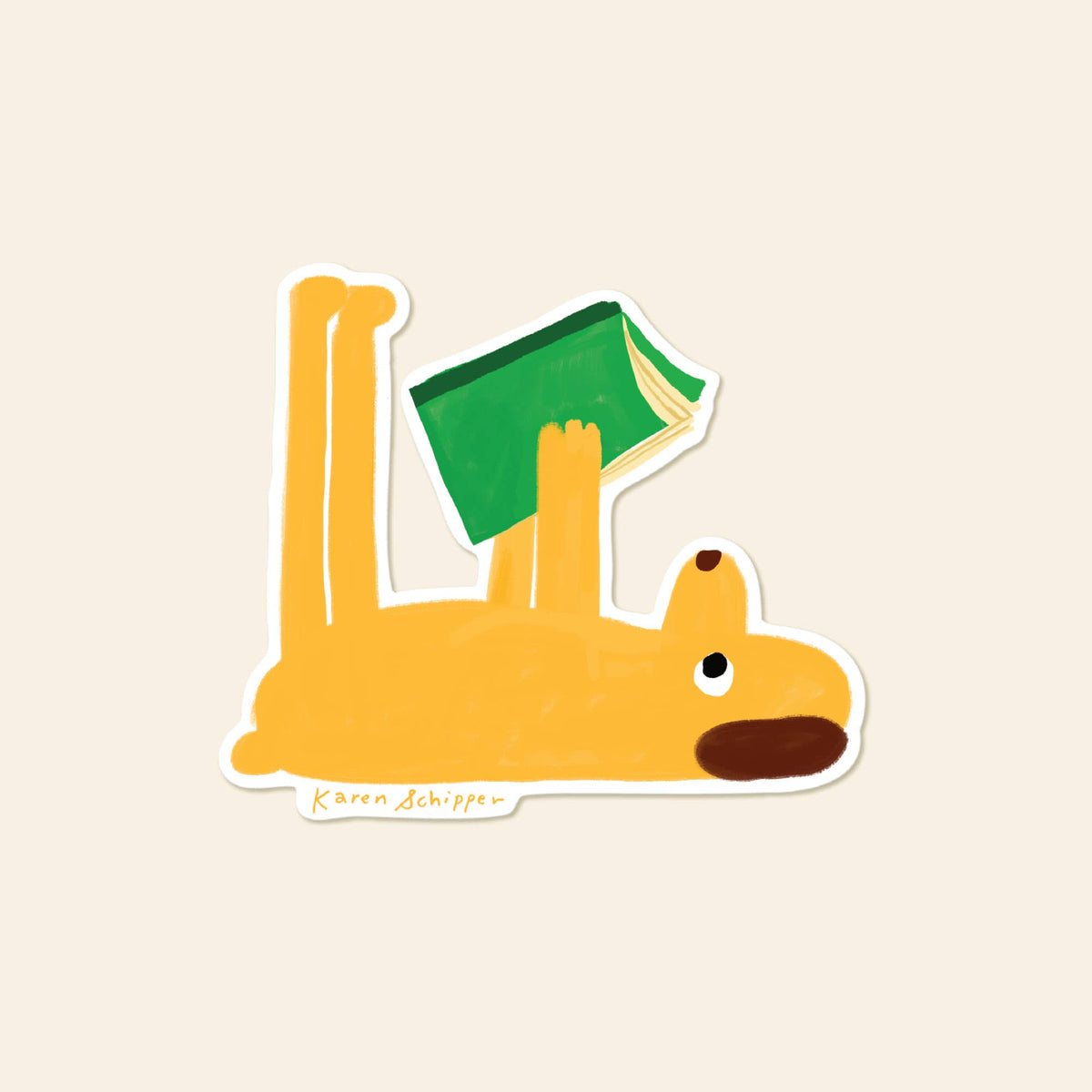 Vinyl sticker of a yellow dog lying on its back and reading a green book