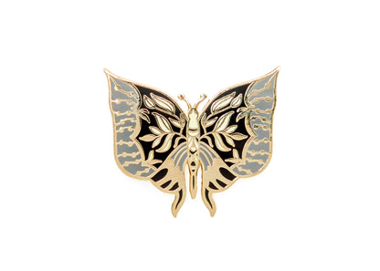 Moth enamel pin with symmetrical pale blue, black, and gold wings.