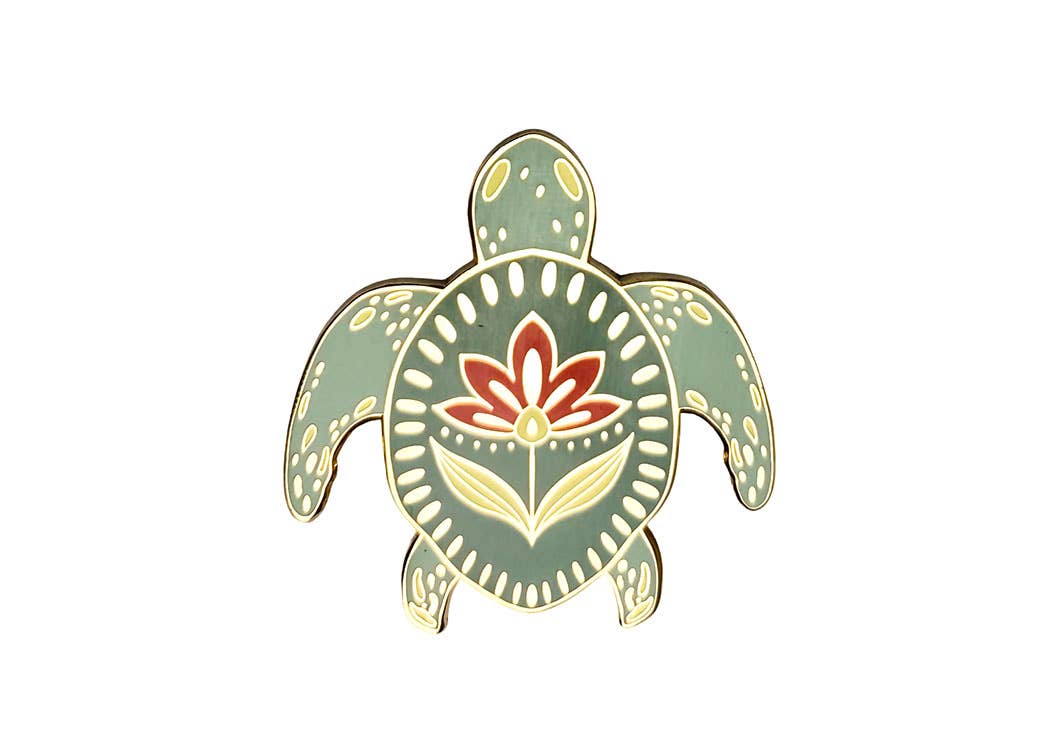 Enamel turtle pin with an olive green shell, gold outline, and flower design