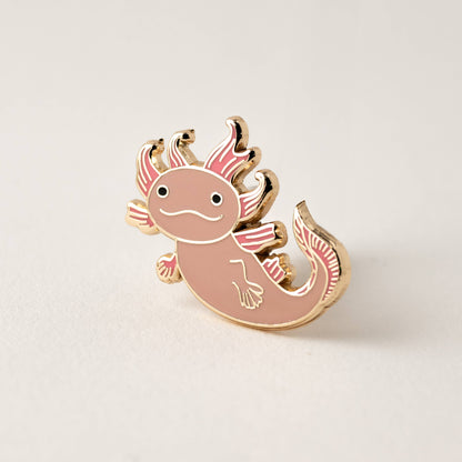 Pink axolotl enamel lapel pin with gold border, curled tail and raised fins