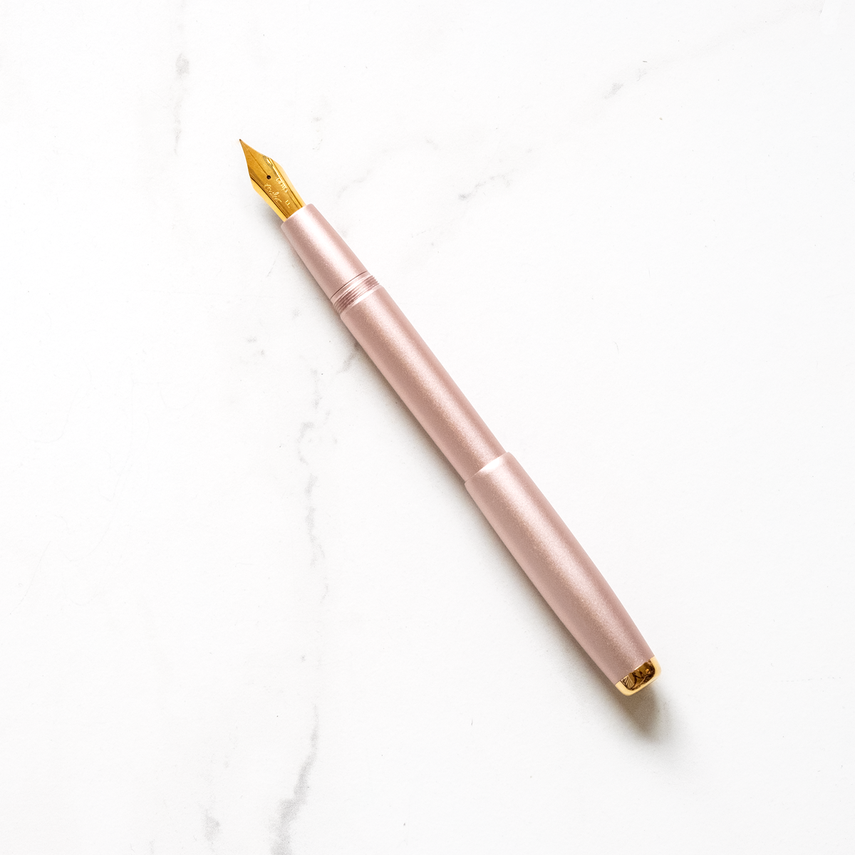 Fountain pen with rose-pink barrel and gold nib