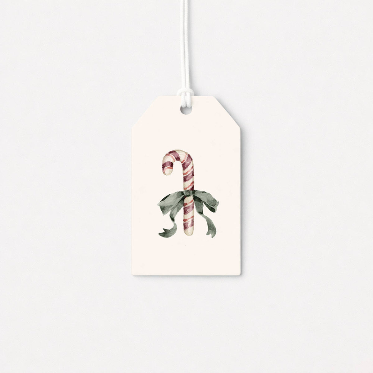 White gift tag with candy cane and holly illustration, attached hanging string
