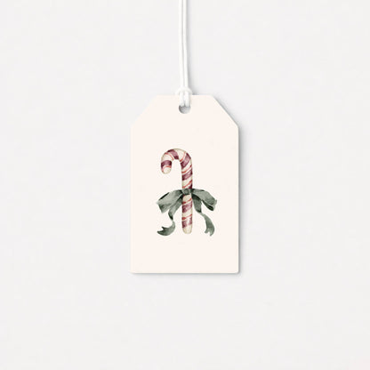 White gift tag with candy cane and holly illustration, attached hanging string