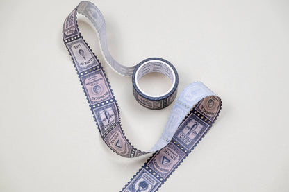 Washi tape with blue stamp and banknote pattern, shown with matching roll
