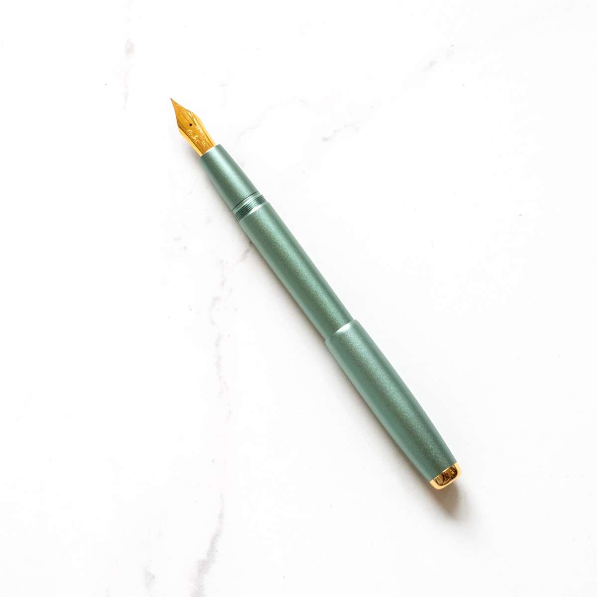 Fountain pen with mint-green barrel and gold nib