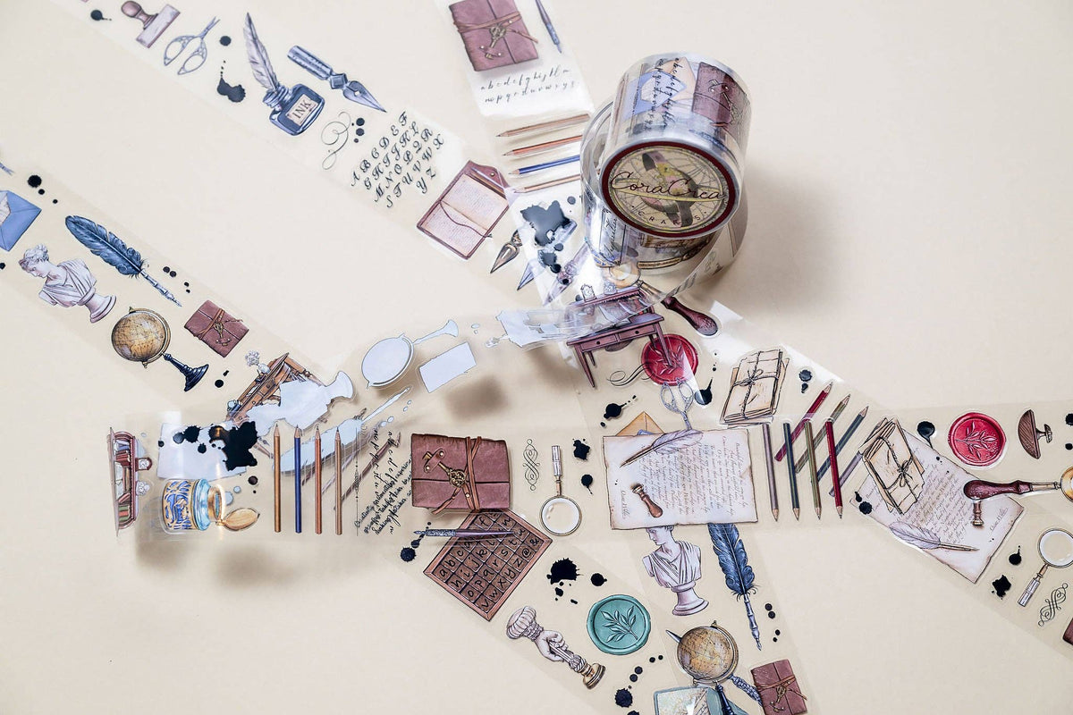 Decorative transparent tape with vintage office icons, shown rolled on core