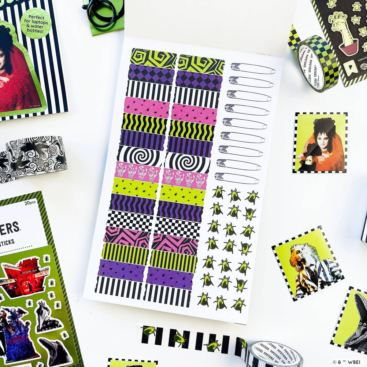 Sticker book page with colorful stripe bands and small green insect stickers