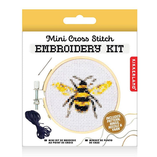 Mini cross-stitch embroidery kit with bee pattern on a hoop, needle and yarn shown