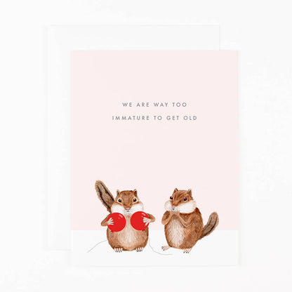 Greeting card with two squirrels holding red balloons and text about getting old