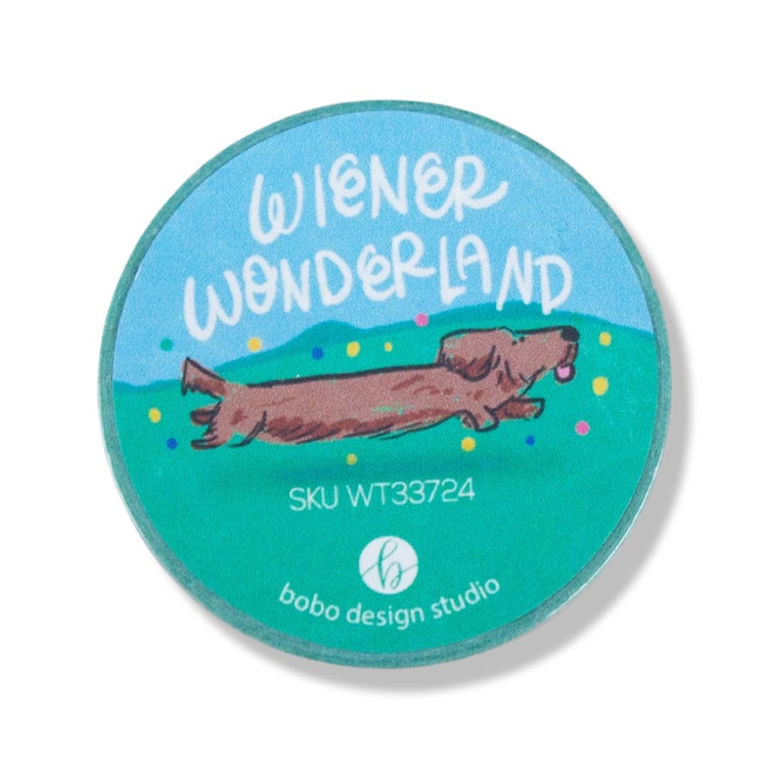 Round washi tape roll, blue-green design with Wiener Wonderland text and dachshund
