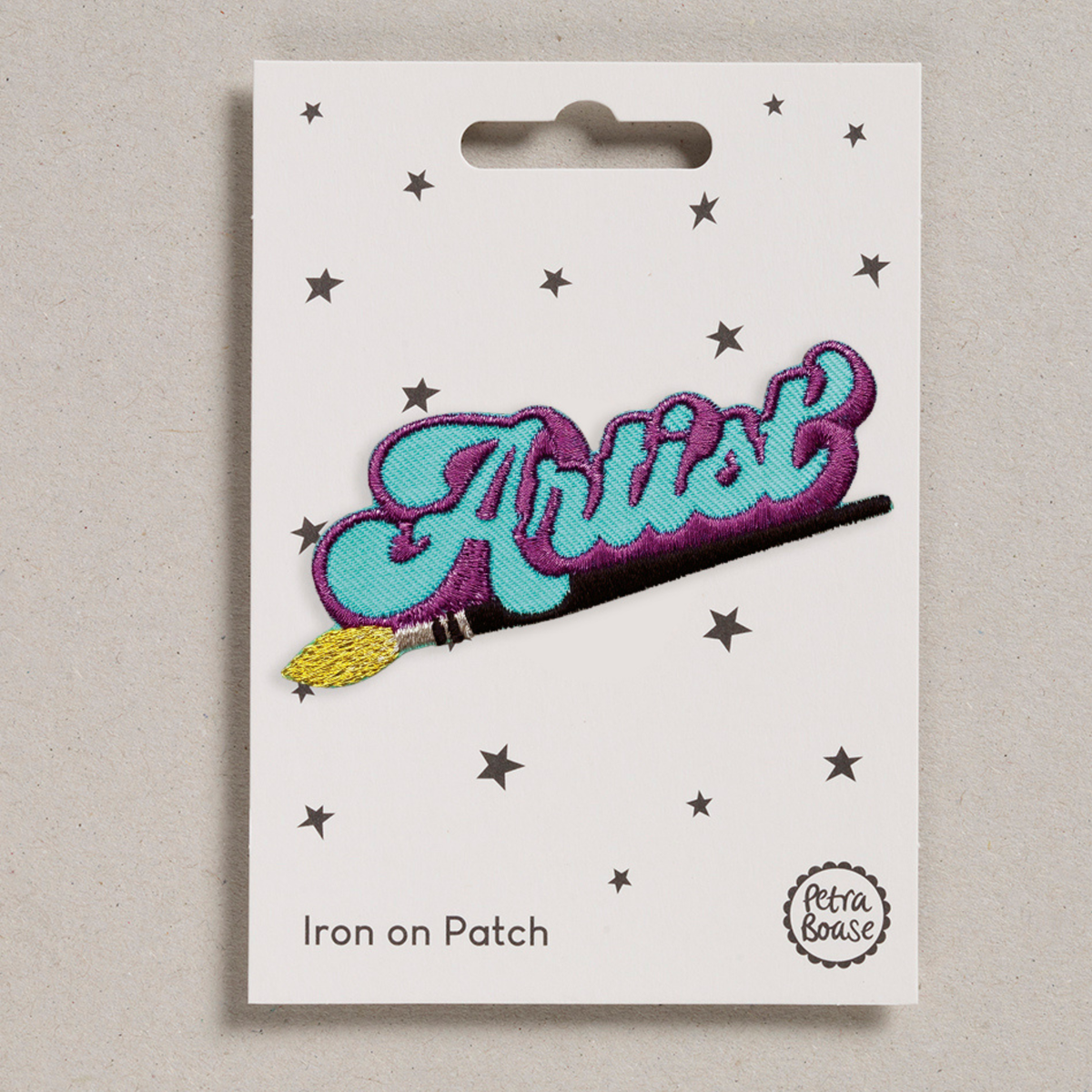 Iron-on patch with turquoise cursive 'Artist' lettering, purple outline, and yellow star