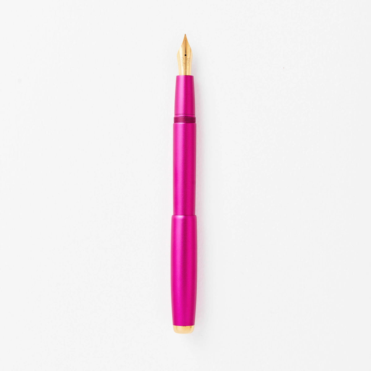 Magenta fountain pen with gold nib, shown upright