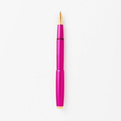Magenta fountain pen with gold nib, shown upright