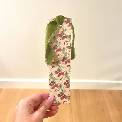Strawberry-print double bookmark with olive-green velvet ribbon edging