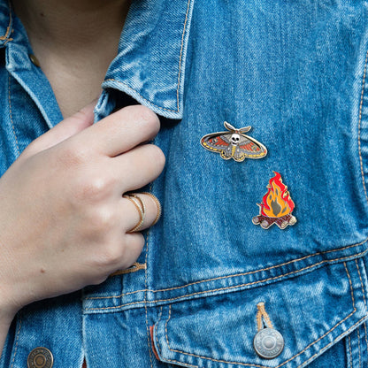 Death moth skull pin on blue denim jacket pocket