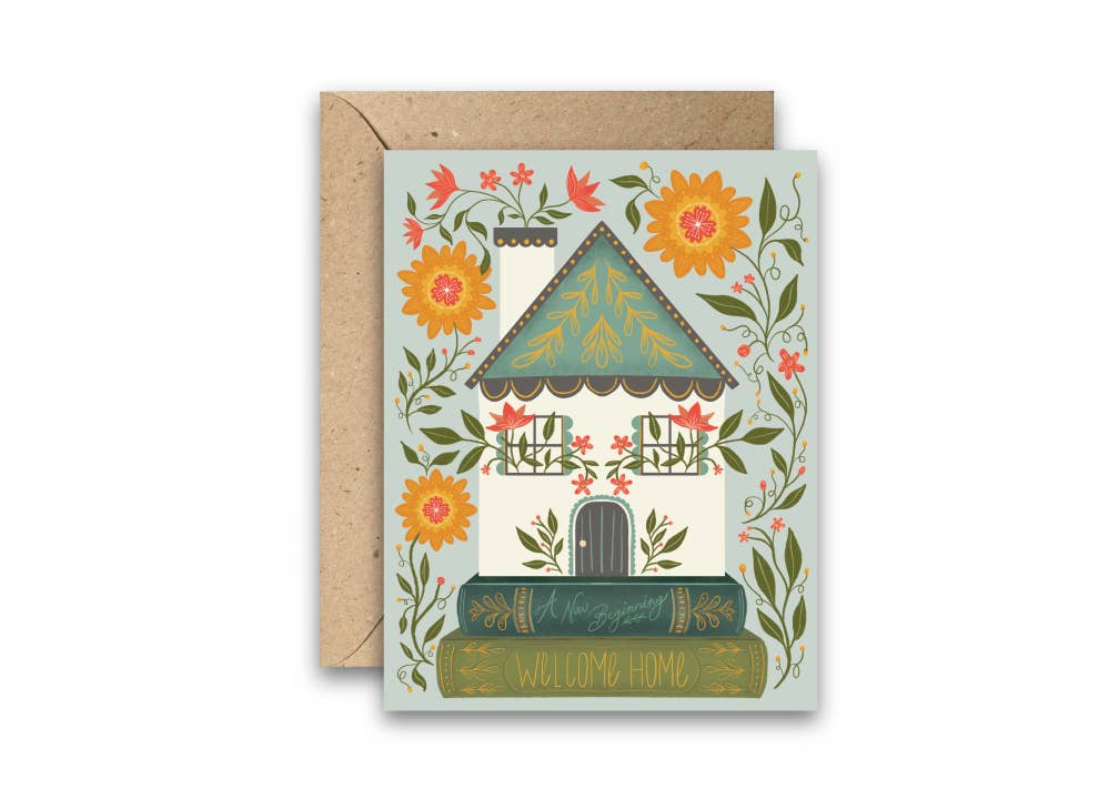 Folk-art housewarming greeting card with a floral cottage illustration and kraft envelope