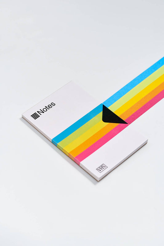 VHS-themed notes notepad with rainbow stripes and black corner bookmark graphic