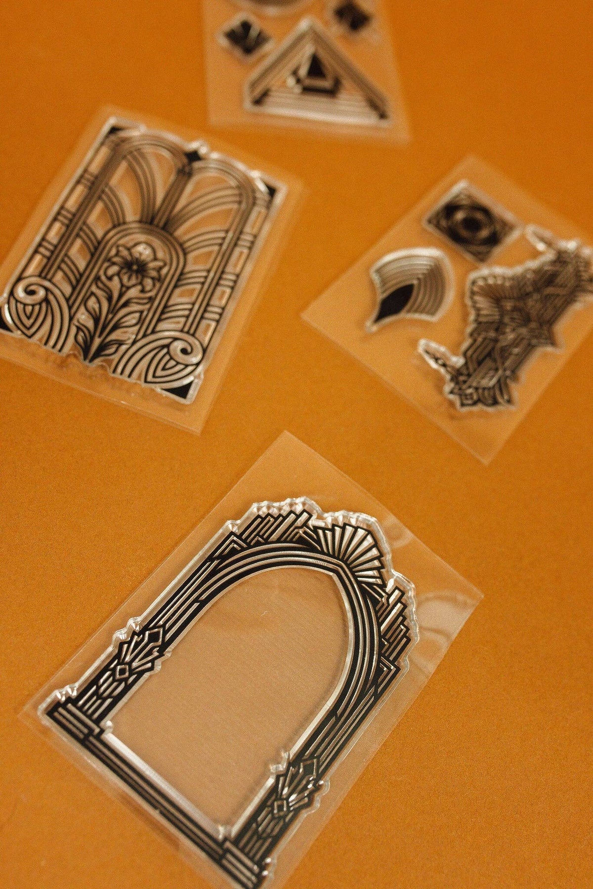 Clear stamp set with decorative frame and building-like art deco motifs in plastic sleeves