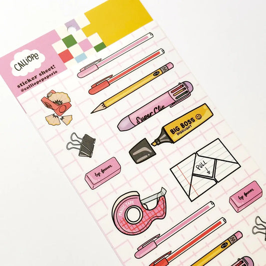 Diagonal view of clear sticker sheet with pens, highlighters, clips, and labels
