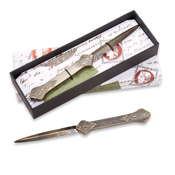 Vintage letter opener with ornate brass-toned handle, in dark presentation box