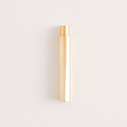 Brass refillable writing pen, cylindrical body with copper-toned tip.